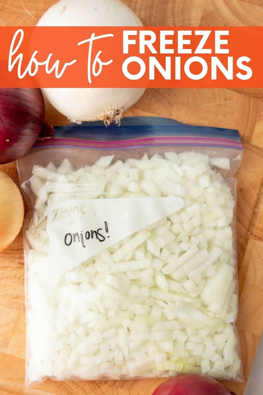 Close-up of a freezer bag filled with diced onions on a cutting board with three whole onions beside it. A text overlay reads, "How to Freeze Onions."