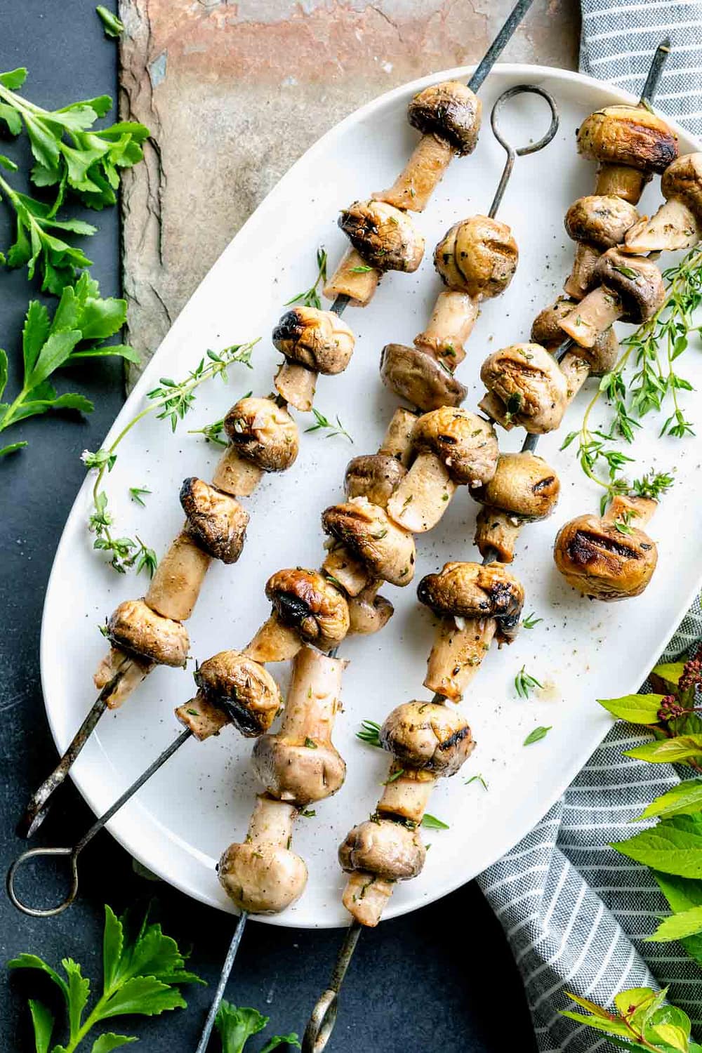 grilled mushroom kebabs on a white platter