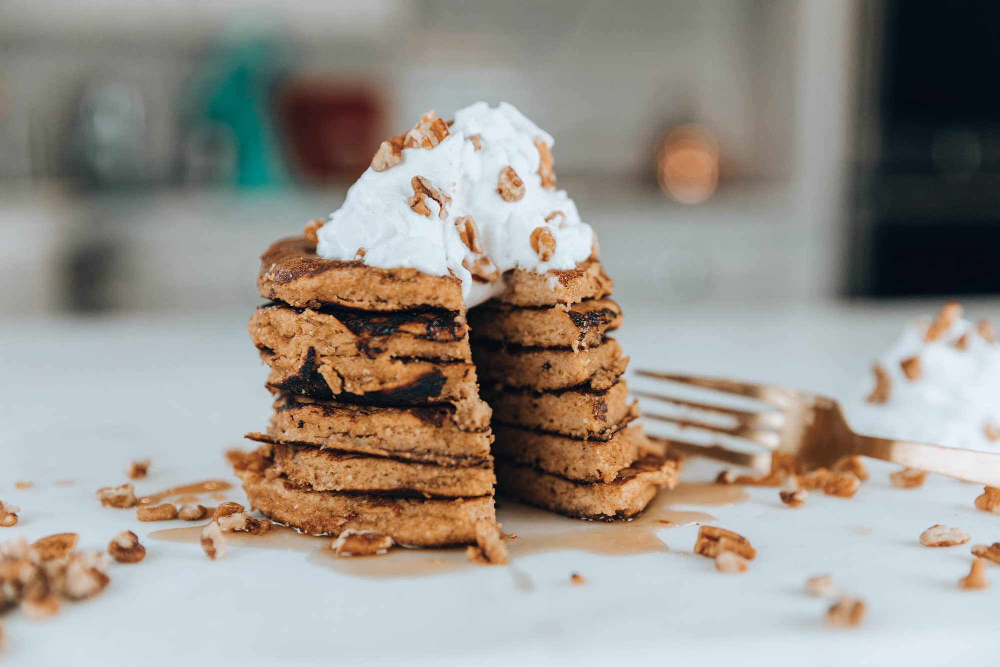 Easy pumpkin spice protein pancakes with coconut whip cream on top