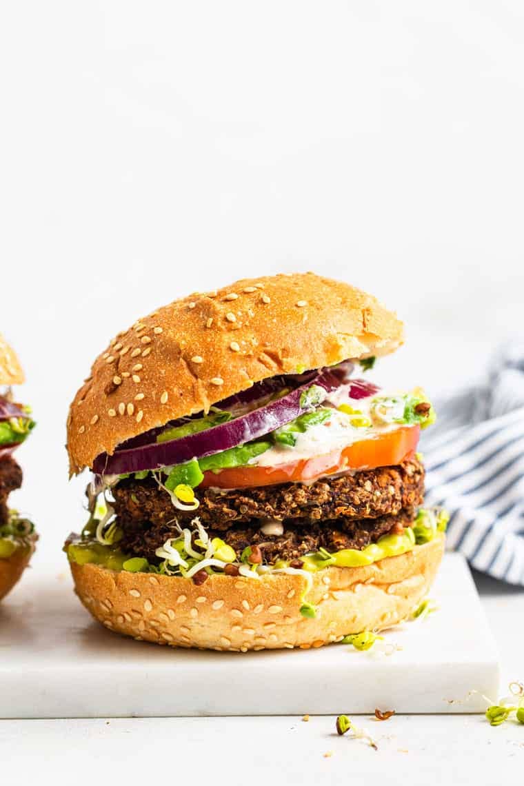 black bean burgers on a bun with onion, tomato and lettuce