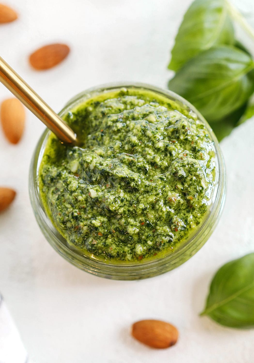 This Simple Basil Almond Pesto recipe combines fresh, delicious ingredients that is easily made in just 10 minutes!  So versatile and perfect with pizza, pasta, chicken, shrimp or veggies!