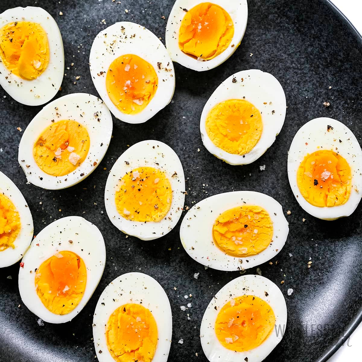 Air fryer hard boiled eggs on a plate.