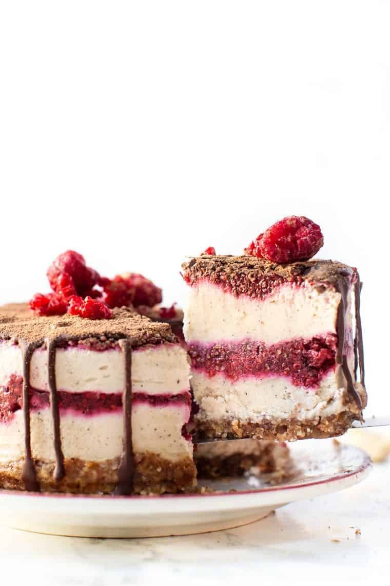 Slice of Mini No-Bake Raspberry Cheesecake being lifted from cake